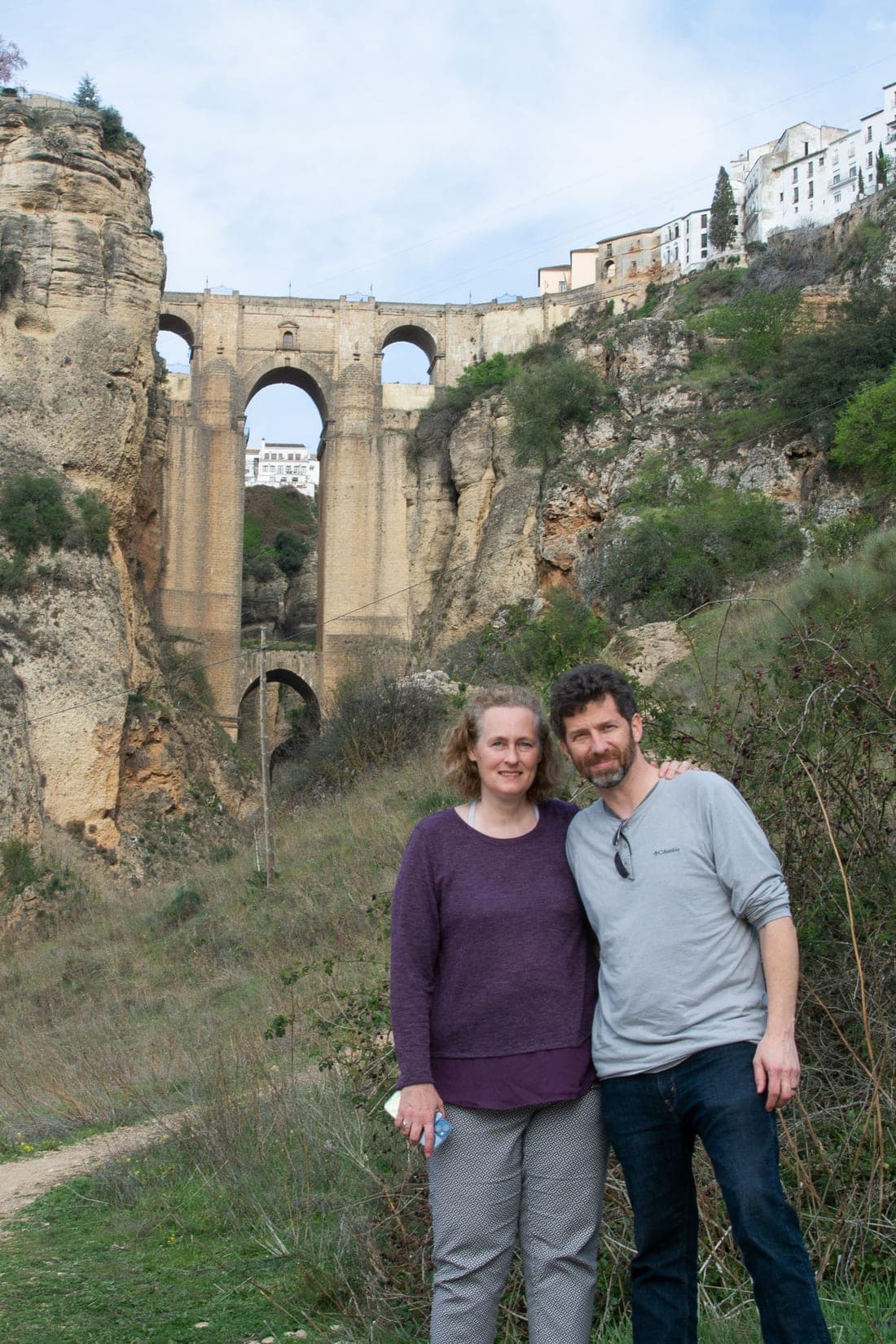 Brandon and Anne in Ronda, Spain, with the Puente Nuevo bridge spanning the gorge behind them